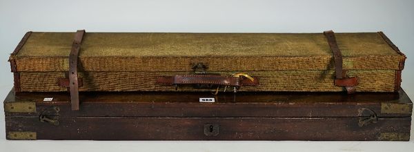 A mahogany and brass bound gun case (interior lacking) 84cm wide, and a canvas shotgun travelling case, 82cm wide, (2).