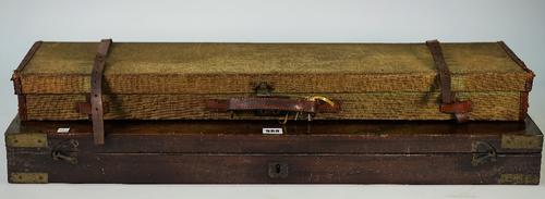 A mahogany and brass bound gun case (interior lacking) 84cm wide, and a canvas shotgun travelling case, 82cm wide, (2).