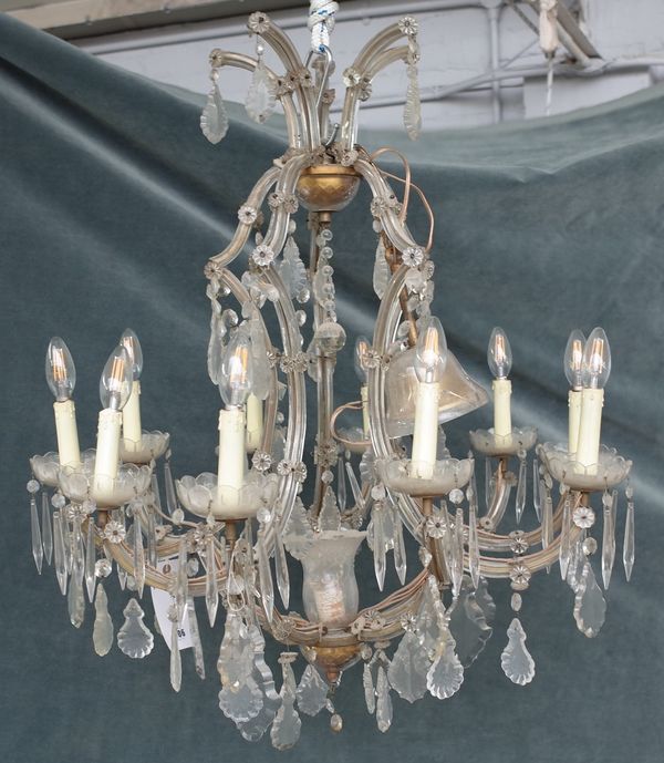 A 20th century glass ten-light chandelier, with scrolling branches and hung with faceted drops, 107cm drop x 73cm wide.