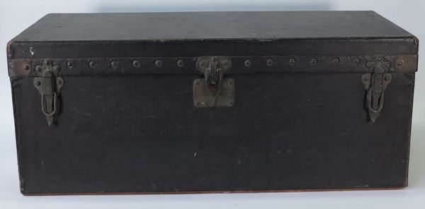 An early 20th century Louis Vuitton black leather motoring trunk, with sloping back, chrome rivets and lock plate, the canvas lined interior (lacking...