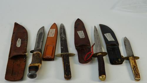 Two early 20th century bone handled hunting knives and two daggers, with leather sheaths, including an example by William Rodgers, length of largest...