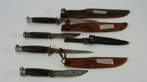 Four early 20th century steel bladed knives, with leather sheaths, including examples by Marble's U.S.A, Milbro Kampa and Gebr. Grafrath, length of...