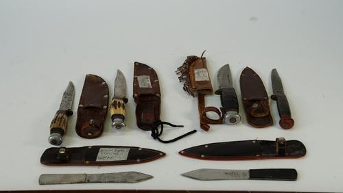 William Rodgers, Sheffield, four early 20th century hunting knives and two throwing knives, with leather sheaths, length of largest 23cm, (6)