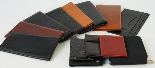 A black ostrich leather wallet by Dunhill, six further Dunhill wallets, a Mont Blanc mobile phone case and a brown leather wallet, an Audemars Piguet...