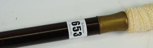 A 20th century carved bone and hardwood walking stick, the handle carved as mythological beast and with a screw-off cap opening to reveal a compass,...