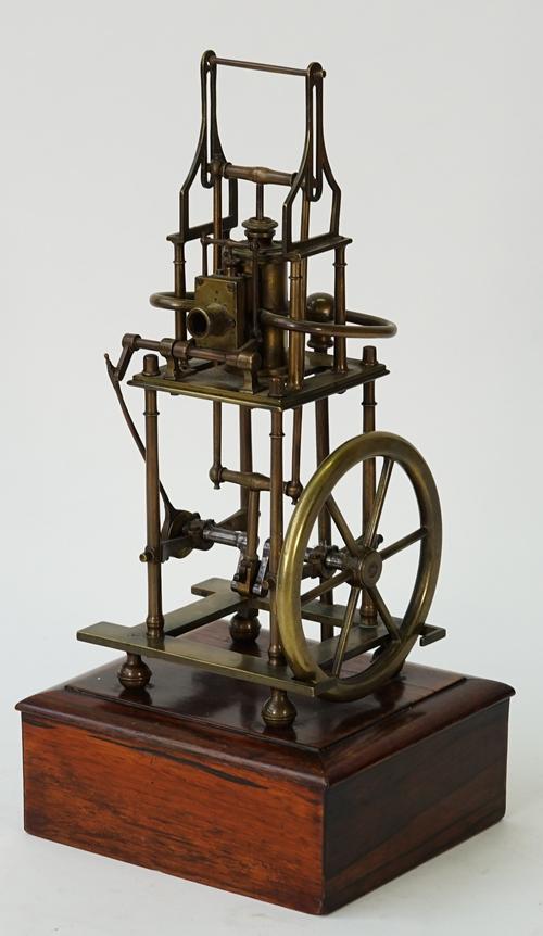 A brass model of a four pillar table engine, 20th century, the single vertical cylinder with valve chest, the crankshaft is supported in main...