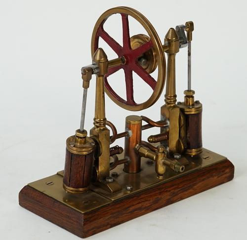 An early live steam model of a Pendulous oscillating engine, 20th century, the twin vertical mahogany-lagged oscillating cylinders with piston rods...