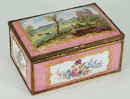 A 19th century enamel casket, the hinged dome cover painted with a pastoral scene, the sides with panels of floral sprays against a pink ground, 23cm...