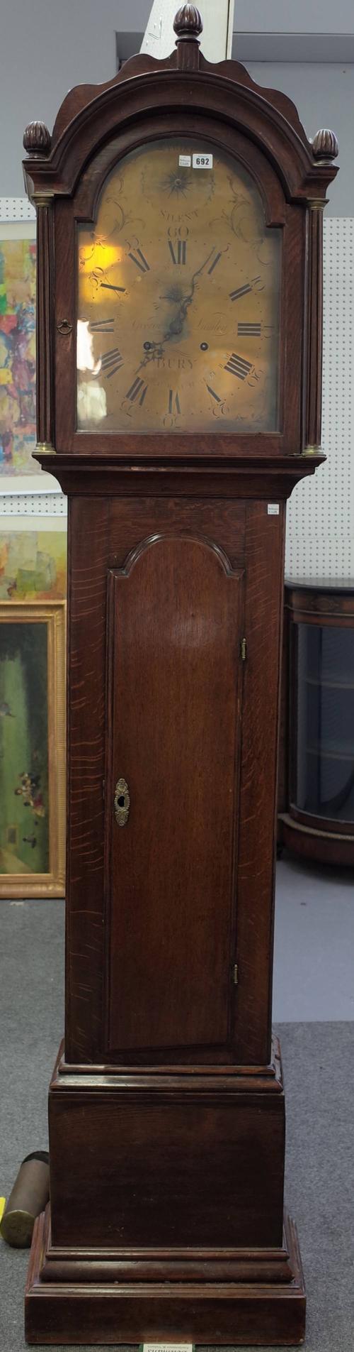A George III month-going oak longcase clock, the brass arch top dial detailed 'George Lumley, Bury', two weights and pendulum, 221cm high.