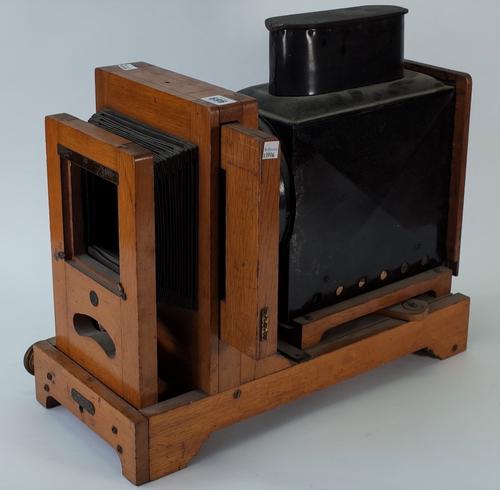 An early 20th century oak and tin horizontal enlarger, the front with an applied plaque detailed 'The Colonel Patent 14137/1913', (lacking lens),...