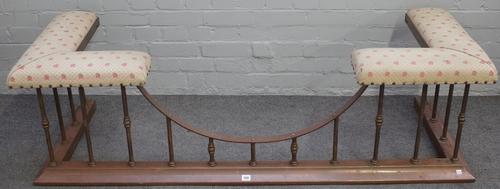 An early 20th century brass and cream upholstered club fender with sloped curb, 167cm wide x 61cm deep, internal measures 130cm wide x 42cm deep.