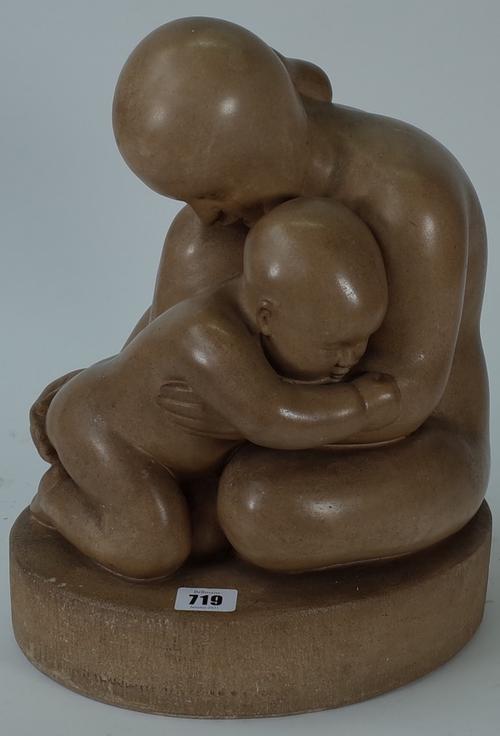 A carved stone figure group of a mother and child, unsigned, 34cm high.