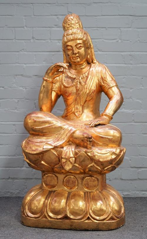 A large modern giltwood model of a Buddha on a lotus base, 122cm high.