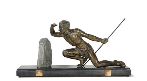 A 20th century patinated spelter sculpture of a kneeling warrior holding a spear, mounted on a black marble base, 77cm wide.