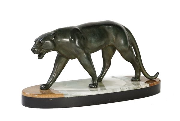 A patinated spelter sculpture of a panther, mounted on an oval onyx and black marble base, unsigned, 44cm wide.