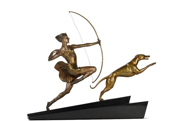 A. Bourquet; a patinated bronze sculpture of Diana the huntress with a hound, mounted on a stepped inclined black marble base, 51cm wide.