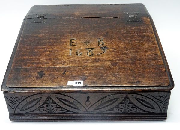 A 17th century oak slope front bible box, detailed E+B 1689, 58cm wide x 23cm high.