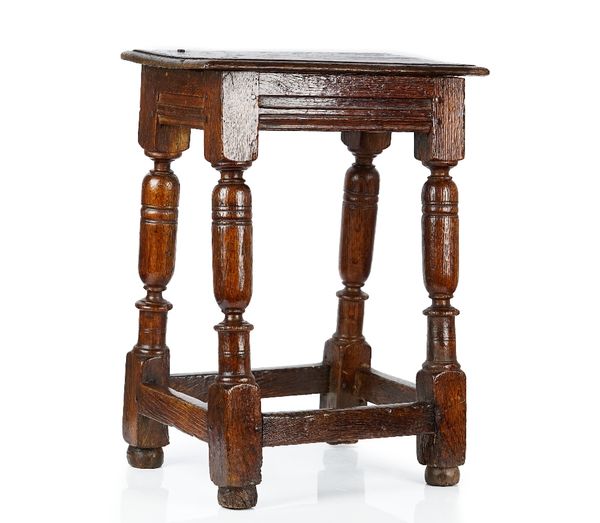 A 17th century oak joint stool on turned supports united by perimeter stretcher, 38cm wide x 58cm high.