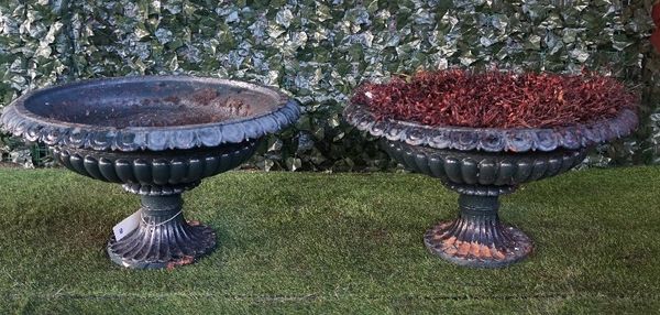 A pair of late 19th century green painted cast iron shallow jardinieres with fluted bodies and turned socles, 80cm diameter x 44cm high.