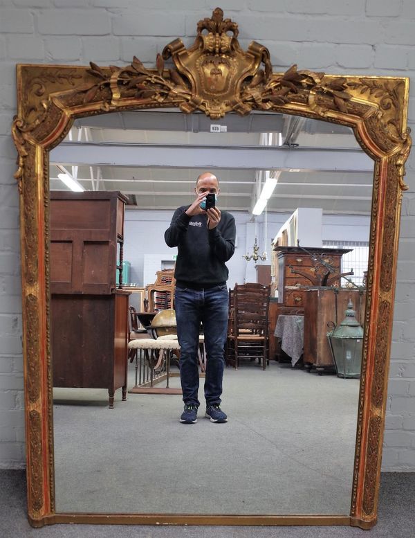 A 19th century French overmantel mirror, with cartouche crest over leaf moulded frame, 125cm wide x 170cm high.