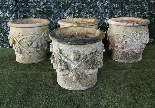 A set of four Vicenza stone jardinieres with fruit and leaf moulded bodies, 55cm diameter x 53cm high.