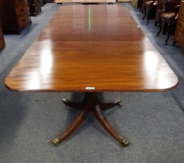 A George III style mahogany 'D' end extending dining table, on pair of turned columns and eight downswept supports, two extra leaves, 114cm wide x...