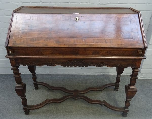 A 17th century Italian walnut bureau, with fitted interior, on square baluster supports, united by 'X' frame stretcher, 117cm wide x 108cm high.