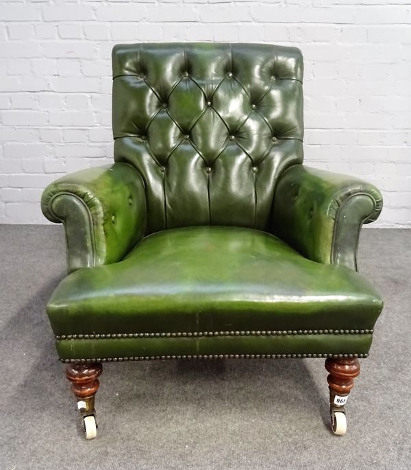 A Victorian green leather upholstered easy armchair, on turned mahogany supports, 80cm wide x 83cm high.