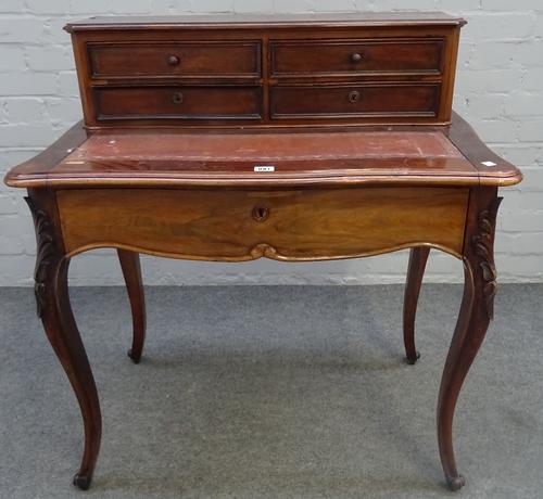 A late 19th century French rosewood lady's writing desk, the fitted superstructure over pull out serpentine writing surface and single drawer on...