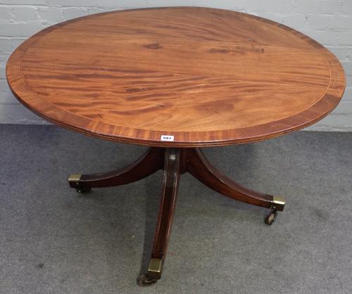 A George III mahogany centre table, the crossbanded circular top on turned column and four downswept supports, 116cm diameter x 70cm high.
