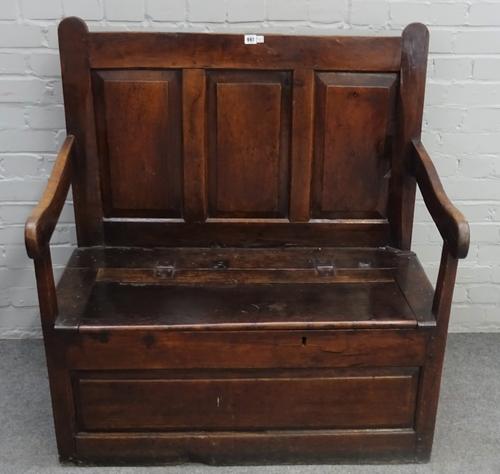 An 18th century oak box seat open arm settle, with triple panel back, 100cm wide x 109cm high.