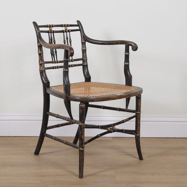 A REGENCY STYLE EBONISED PARCEL GILT DECORATED FAUX BAMBOO OPEN ARMCHAIR
