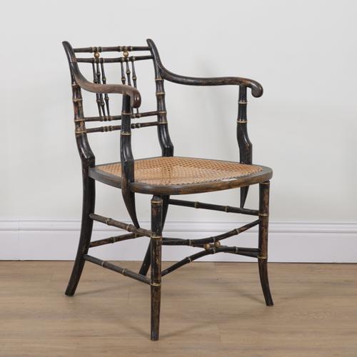 A REGENCY STYLE EBONISED PARCEL GILT DECORATED FAUX BAMBOO OPEN ARMCHAIR
