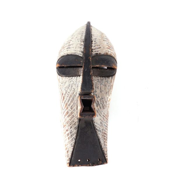 AN AFRICAN TRIBAL MASK IN THE STYLE OF THE SONGYE