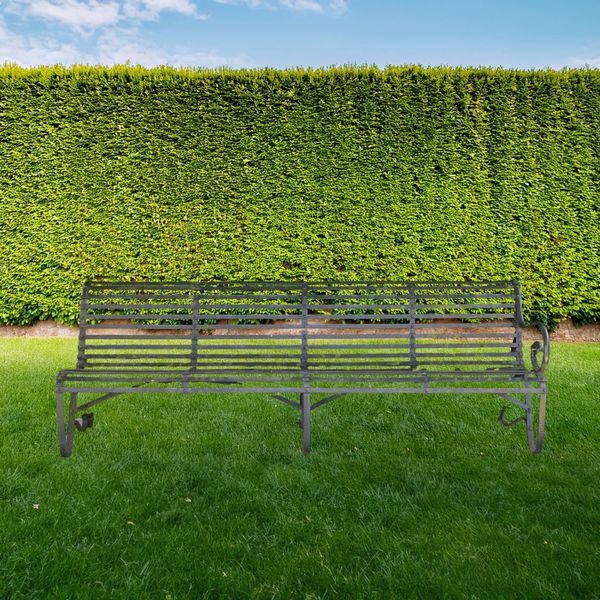 A VICTORIAN DARK GREEN PAINTED STRAP IRON BENCH