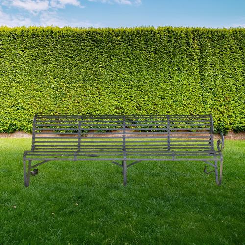 A VICTORIAN DARK GREEN PAINTED STRAP IRON BENCH