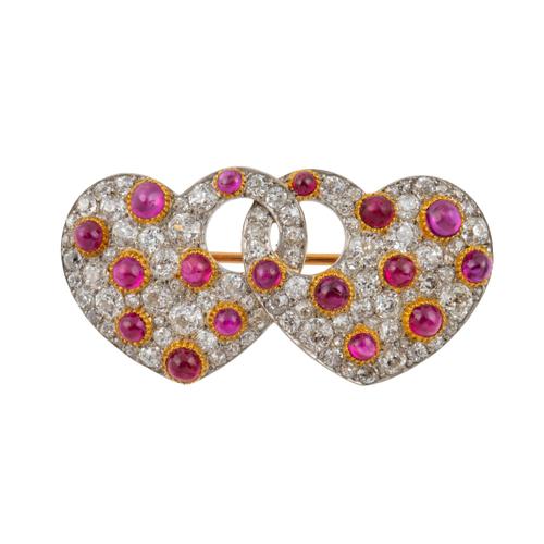 A DIAMOND AND RUBY INTERTWINED HEARTS BROOCH