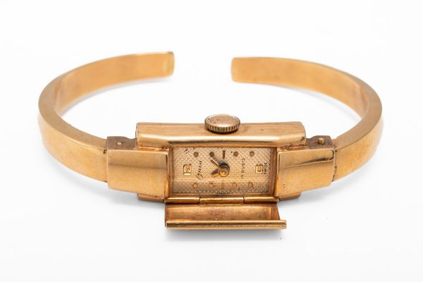 A GOLD BANGLE WATCH