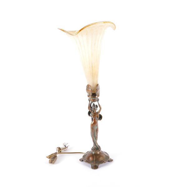 AN ART NOUVEAU STYLE FIGURAL BRONZE AND MURANO GLASS MOUNTED TABLE LAMP