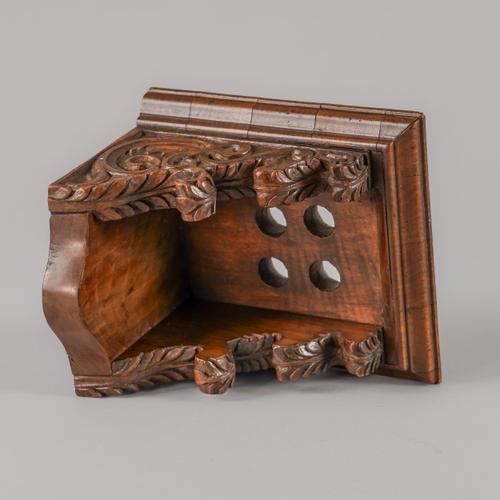 A CARVED WALNUT MINIATURE LANTERN CLOCK BRACKET