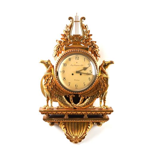 A SWEDISH EMPIRE STYLE GILTWOOD CARTEL WALL CLOCK