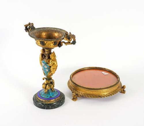 A FRENCH GILT-BRONZE AND CHAMPLEVÉ ENAMEL TAZZA TOGETHER WITH AN EGYPTIAN REVIVAL CENTRE-PIECE STAND (2)