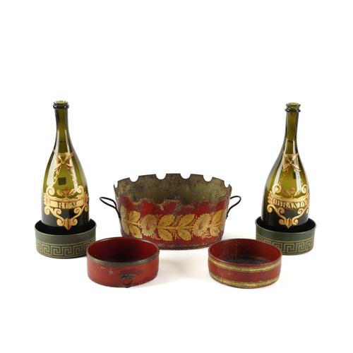 A RED JAPANNED GILT DECORATED MONTEITH AND A PAIR OF GLASS DECANTER BOTTLES TOGETHER WITH VARIOUS WINE COASTERS (7)