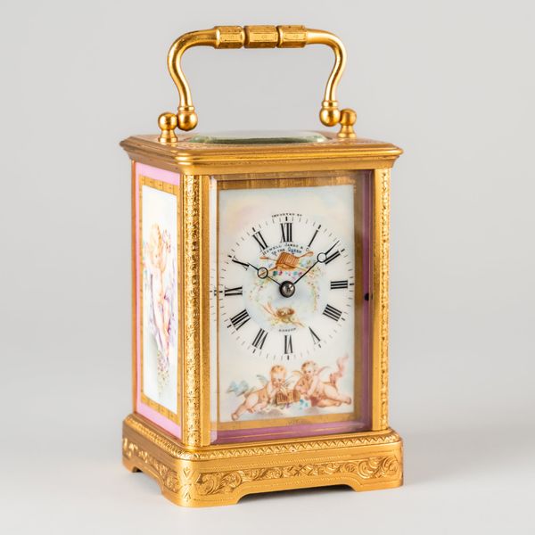 A FRENCH ENGRAVED GILT BRASS AND PORCELAIN TRIPLE-PANELLED CARRIAGE TIMEPIECE