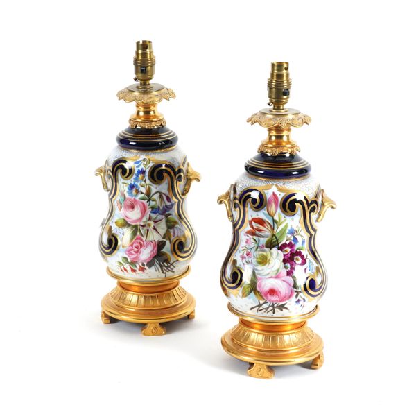 A PAIR OF FRENCH GILT-METAL MOUNTED GILT HEIGHTENED PORCELAIN TABLE LAMPS (2)