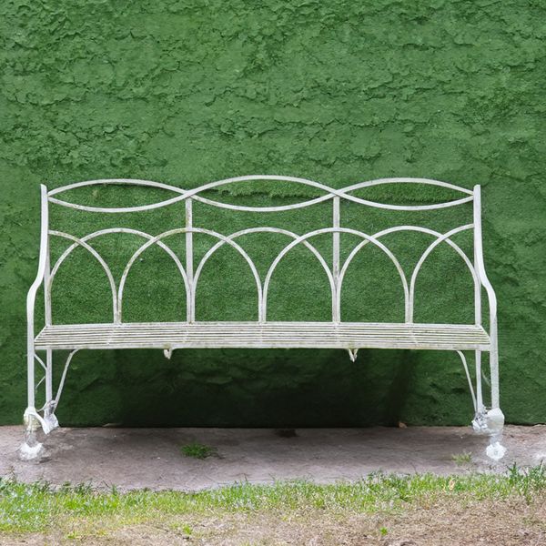 A REGENCY STYLE WHITE PAINTED STRAP IRON CONCAVE GARDEN BENCH