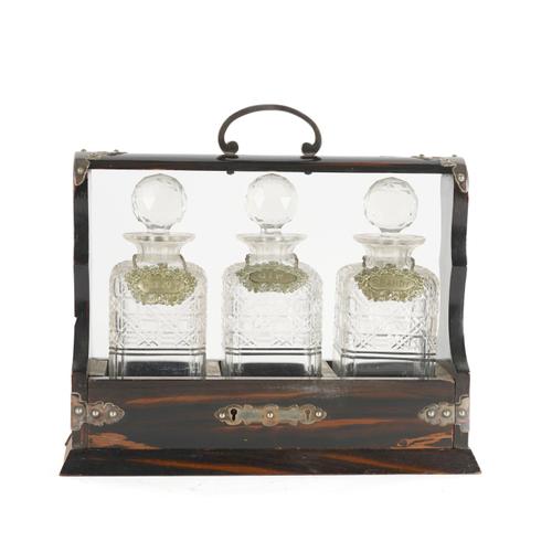 AN EDWARDIAN COROMANDEL SILVER-PLATED THREE BOTTLE TANTALUS