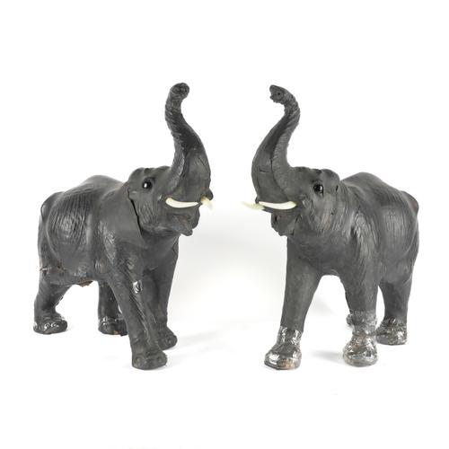 A PAIR OF BLACK LEATHER MODELS OF ELEPHANTS (2)