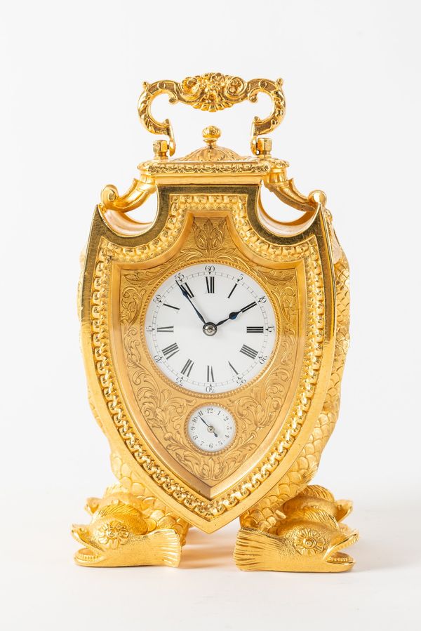 AN UNUSUAL FRENCH GILT BRASS SHIELD-SHAPED STRIKING AND REPEATING CARRIAGE CLOCK