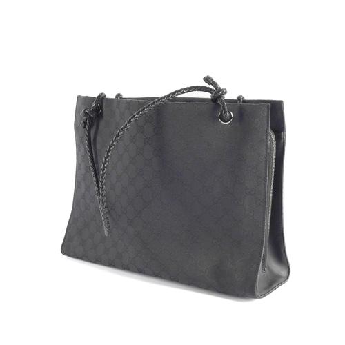 GUCCI: A BLACK MONOGRAM CANVAS HANDBAG